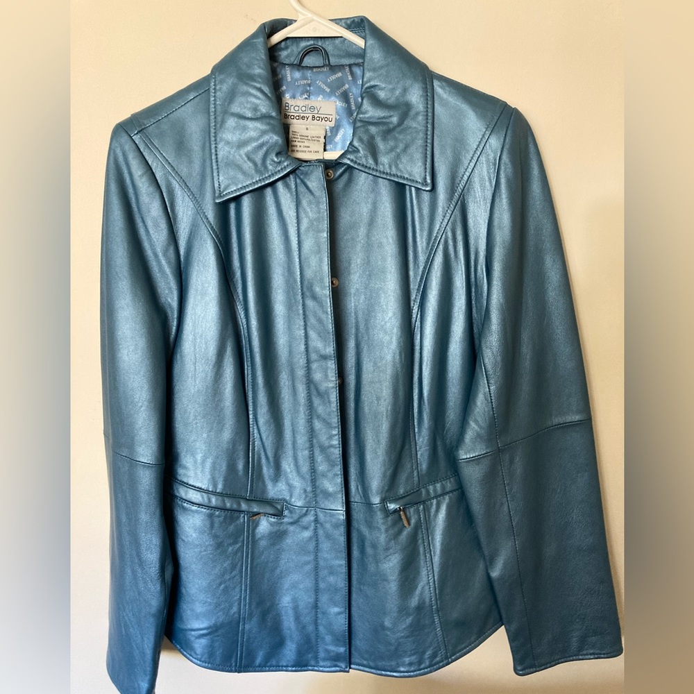 Blue Leather jacket, size small with zippered sleeves. Like new